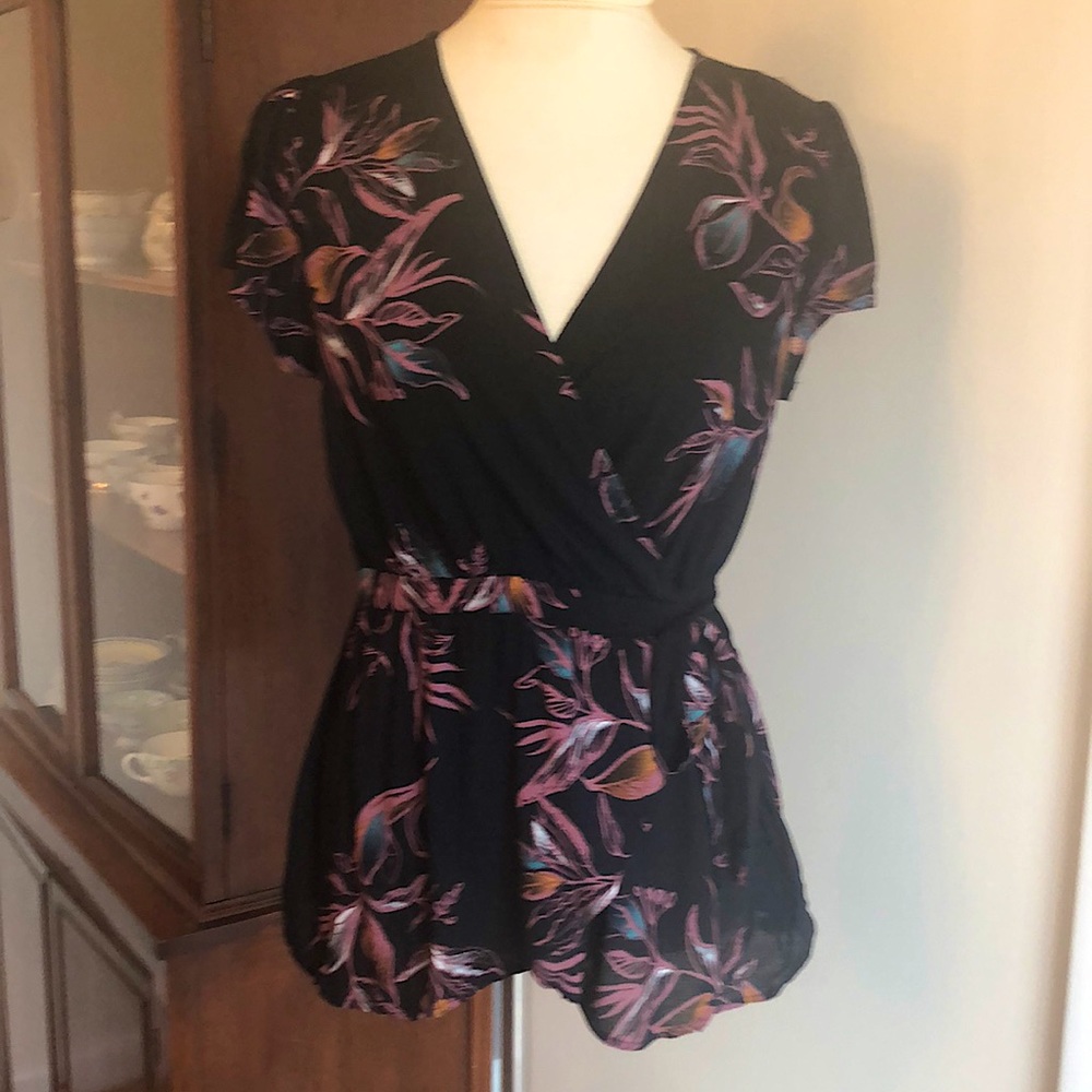 Tie-waist black patterned blouse.